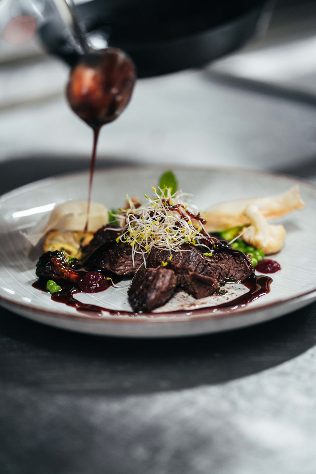 Cascada Rooftop Kitchen signature dish — red wine sauce poured over meat, Willemstad Curaçao