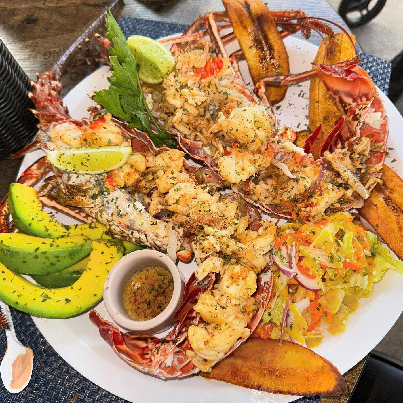 Fresh whole lobster at Kas di Piskado Rondu, Willemstad Curaçao — grilled with avocado and plantain